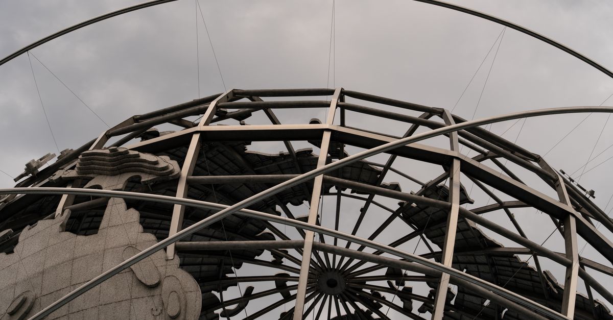 Detailed view of the Unisphere globe with overcast skies, showcasing intricate metal framework.